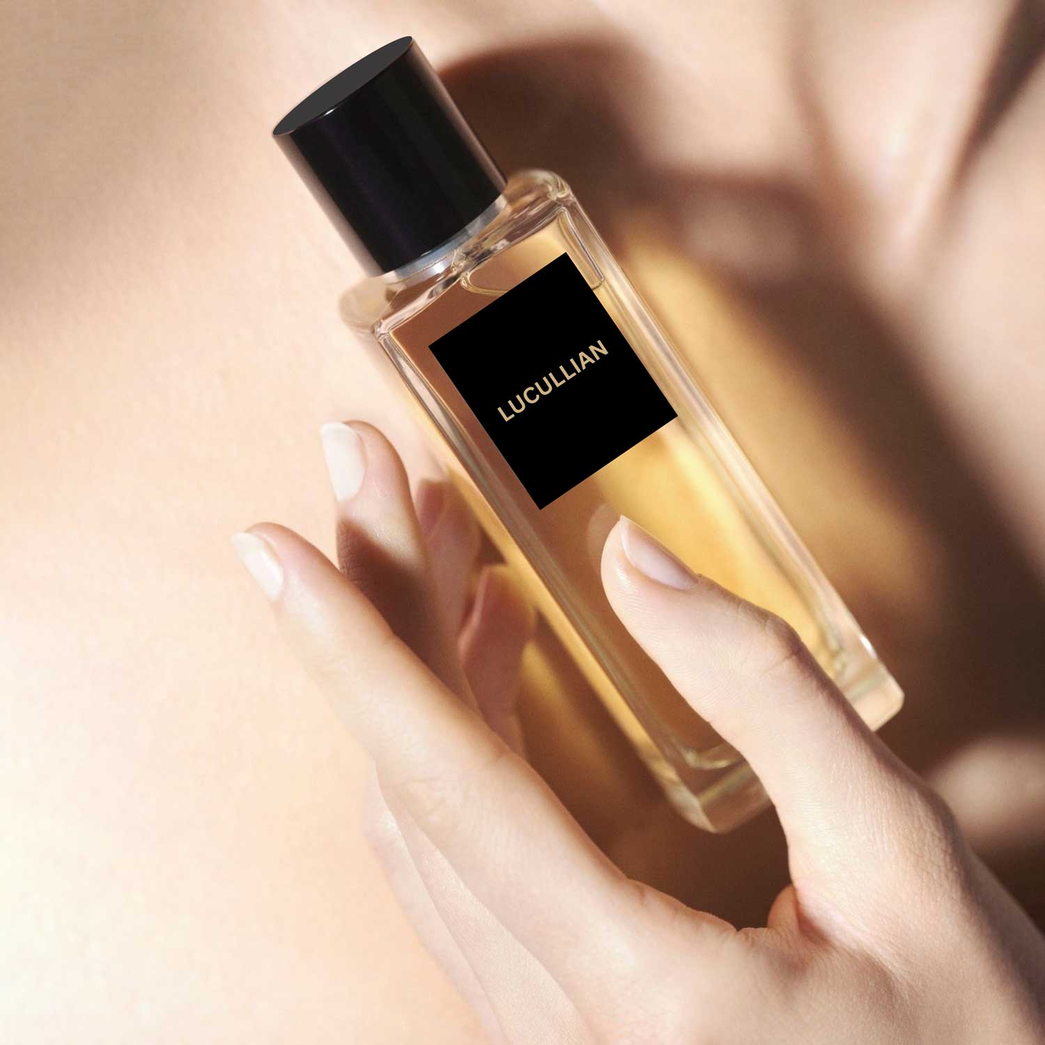 Hand holding a Lucullian perfume bottle against bare skin, clear glass, black cap