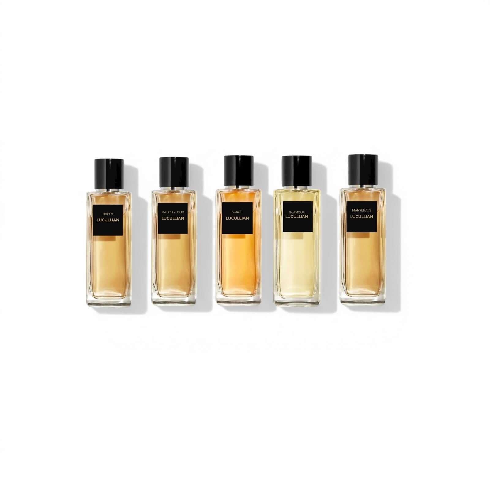 Five luxury perfume bottles with black caps arranged in a row on a white background